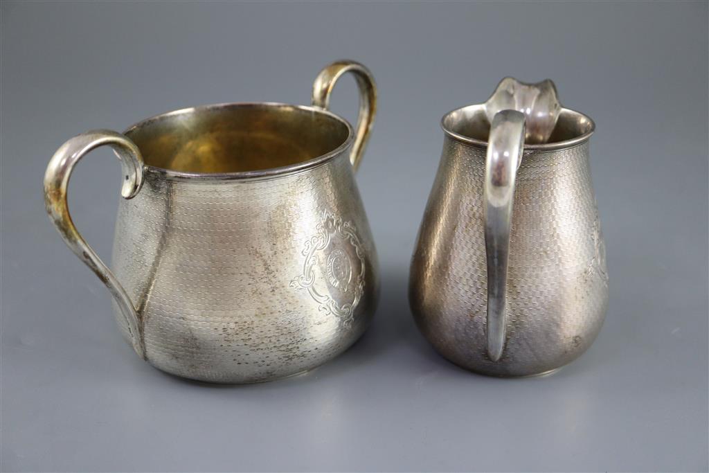 A Victorian engine turned silver three piece tea set by Richards & Brown,